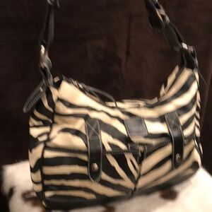 Women’s zebra print shoulder bag, buckles on shoulder strap and matching wallet.